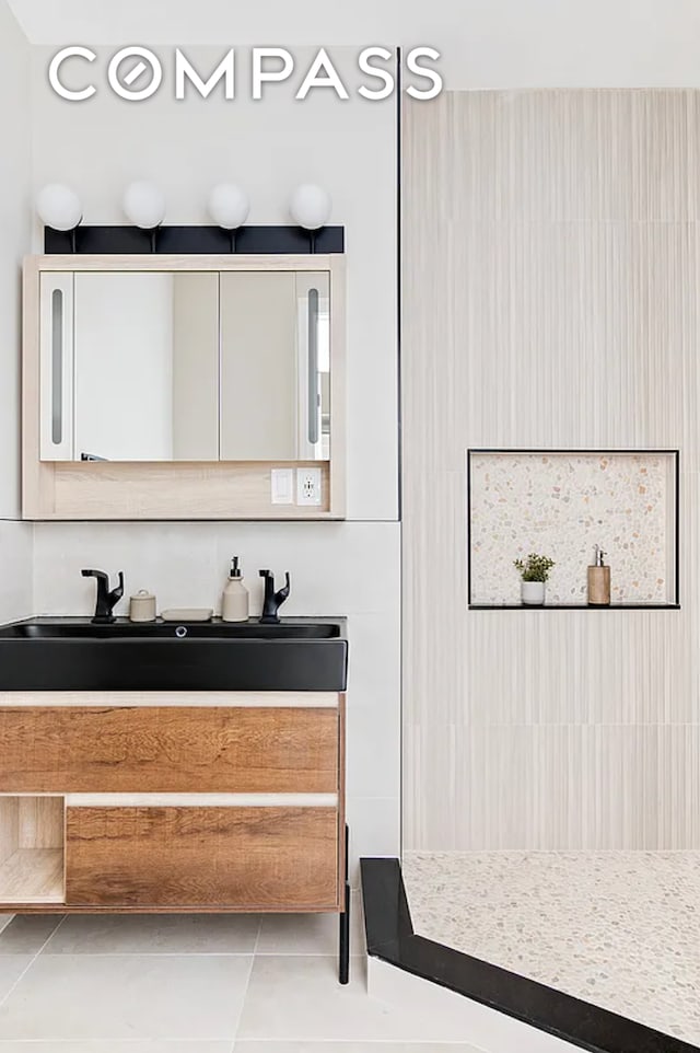 bathroom featuring tile patterned flooring and vanity