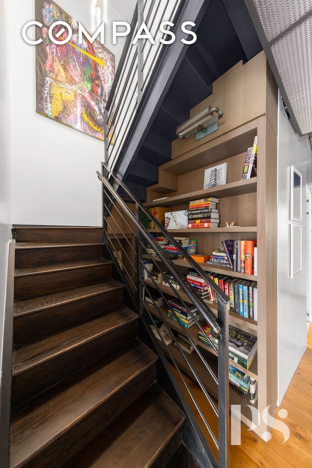 stairway featuring wood finished floors