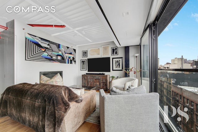 living room with visible vents, expansive windows, and wood finished floors