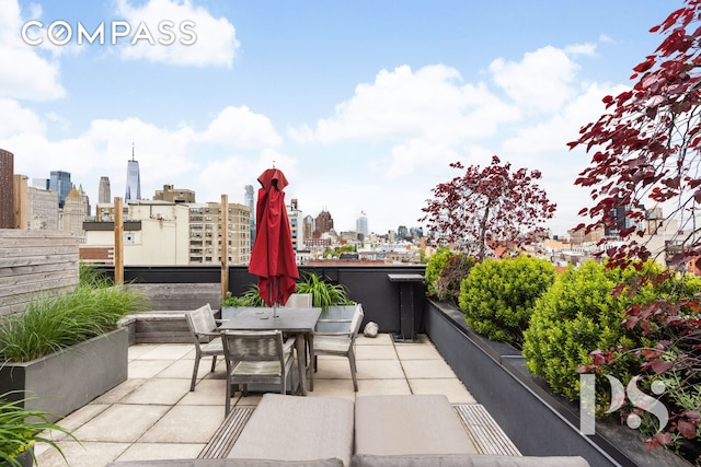 view of patio / terrace featuring a city view and outdoor dining area