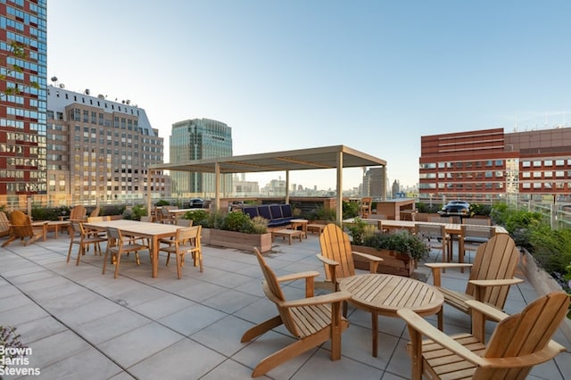 view of patio with a city view and outdoor dining space