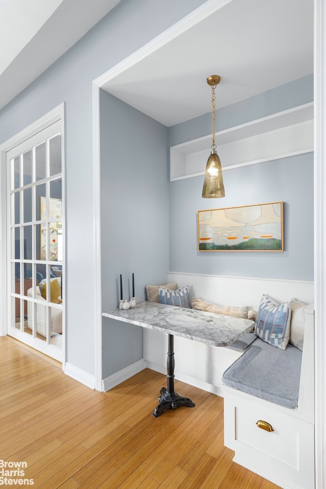 sitting room with baseboards and light wood-style floors