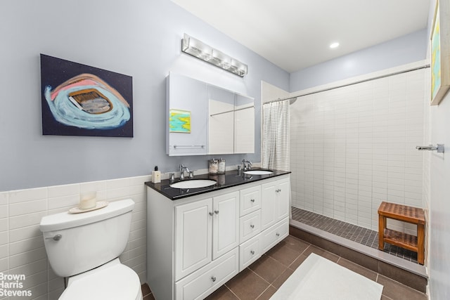 365 Bridge St Unit 22C, New York City, NY 11201 - bathroom with a tile shower, toilet, double vanity, tile patterned flooring, and recessed lighting