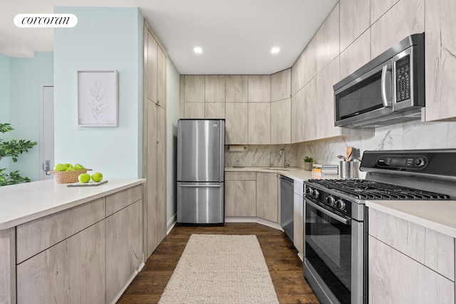 kitchen with visible vents, dark wood-style floors, stainless steel appliances, light countertops, and light brown cabinets