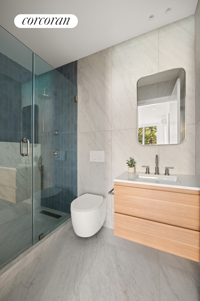 full bathroom featuring toilet, a shower stall, tile walls, and vanity