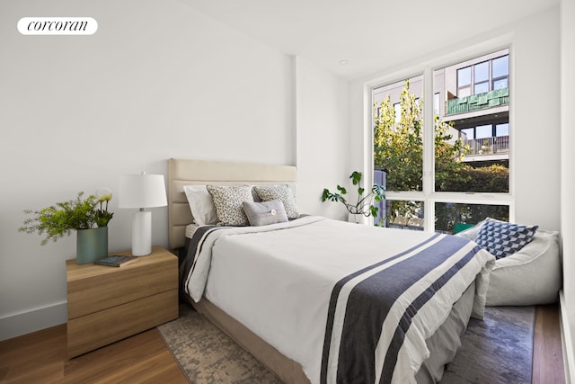 bedroom featuring wood finished floors and visible vents