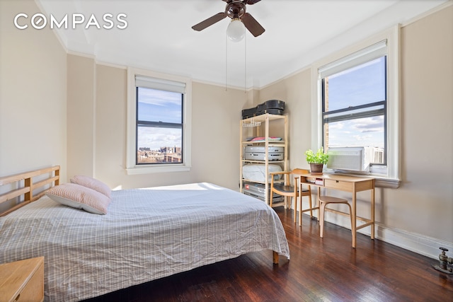 bedroom featuring cooling unit, wood finished floors, a ceiling fan, baseboards, and ornamental molding