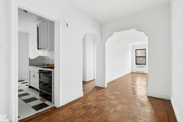 interior space with baseboards and a sink