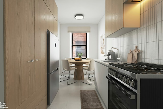 kitchen featuring appliances with stainless steel finishes, modern cabinets, a sink, and tasteful backsplash