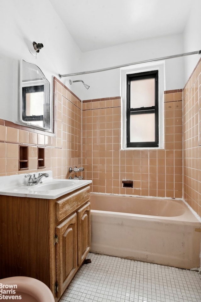 bathroom featuring tile walls, tasteful backsplash, tub / shower combination, vanity, and tile patterned floors