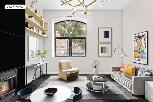 living area featuring wood finished floors, baseboards, an inviting chandelier, and a warm lit fireplace