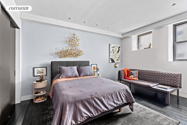 bedroom featuring wood finished floors, visible vents, and baseboards