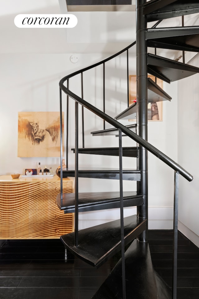 stairway featuring wood finished floors