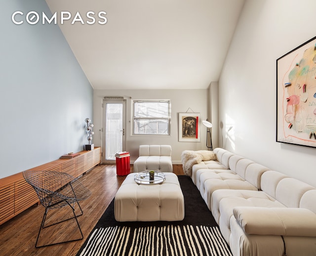 living room featuring vaulted ceiling and wood finished floors