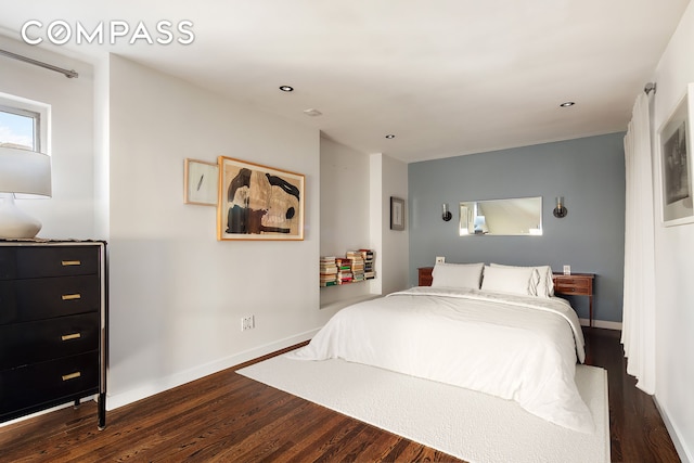 bedroom with dark wood-style floors and baseboards