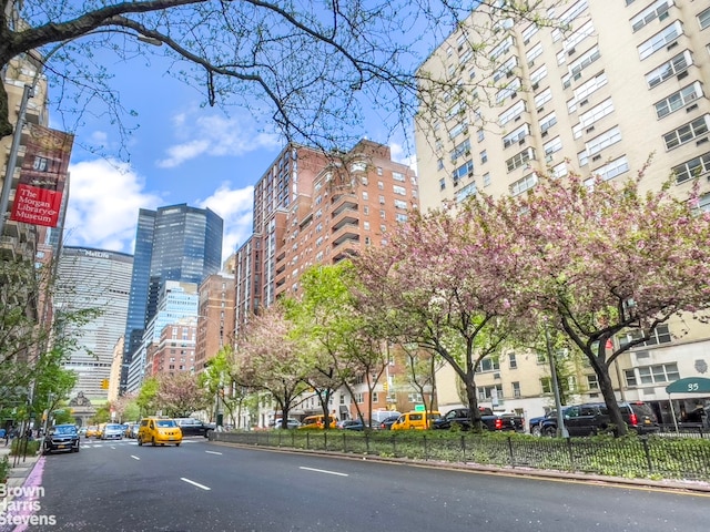 view of property with a view of city and fence
