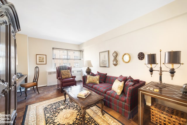 living room featuring baseboards and radiator