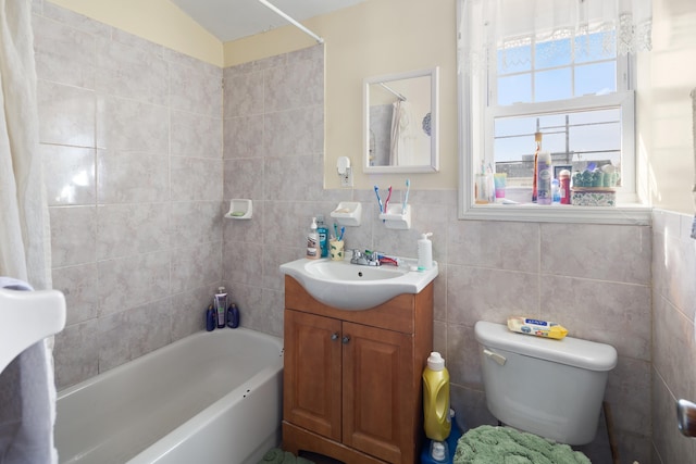 full bath featuring toilet, wainscoting, tile walls, and vanity