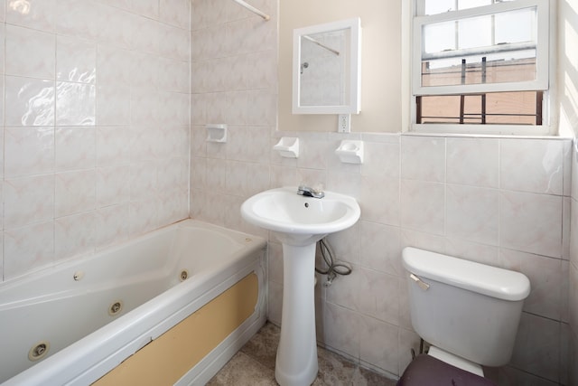 bathroom featuring toilet and tile walls