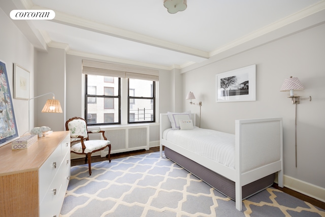 bedroom with light wood finished floors, visible vents, baseboards, radiator heating unit, and ornamental molding