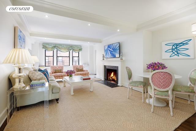 living area featuring recessed lighting, a fireplace with flush hearth, visible vents, and ornamental molding