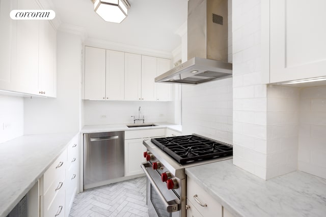 kitchen featuring decorative backsplash, appliances with stainless steel finishes, ornamental molding, wall chimney range hood, and a sink