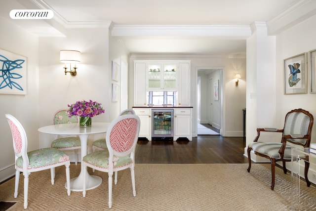 dining space featuring beverage cooler, visible vents, dark wood-type flooring, and crown molding