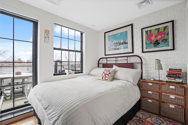 577 Madison St Unit 4B, New York City, NY 11221 - bedroom featuring multiple windows, access to outside, and wood finished floors