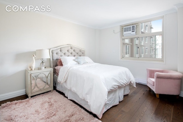 bedroom with baseboards, dark wood-type flooring, a wall mounted AC, and crown molding