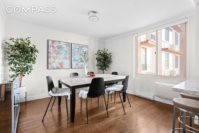 dining area with a baseboard heating unit, baseboards, ornamental molding, and dark wood-style flooring