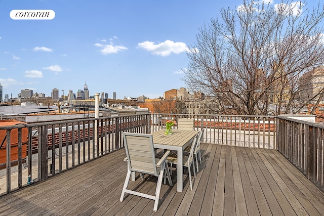 deck with a view of city and outdoor dining area