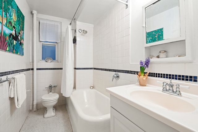 full bath featuring toilet, tile patterned floors, shower / bath combination with curtain, vanity, and tile walls