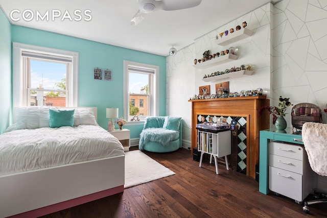 bedroom featuring dark wood-type flooring and multiple windows