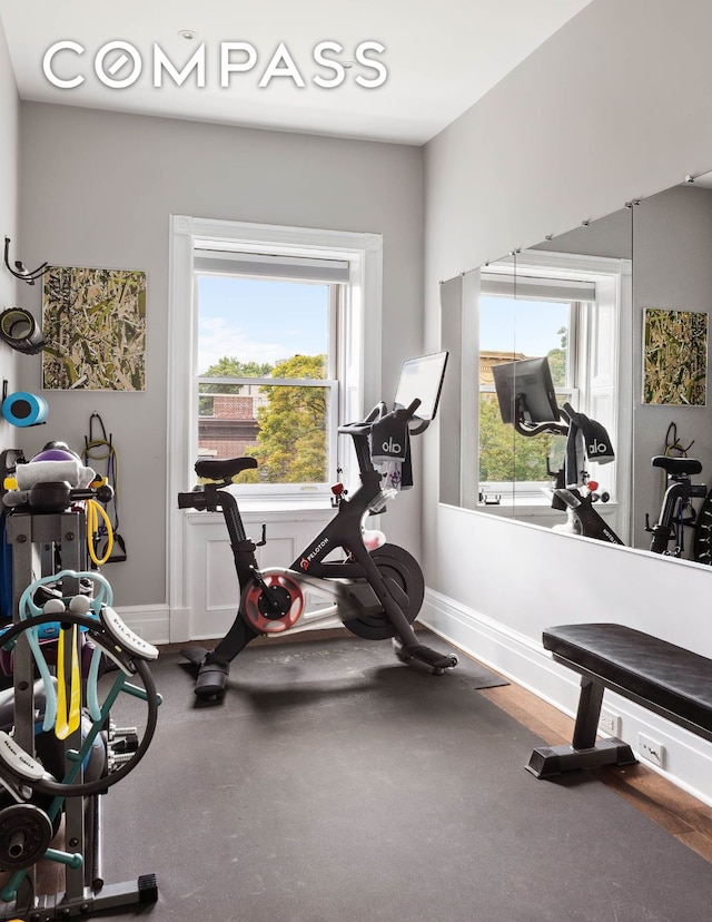 workout room featuring baseboards