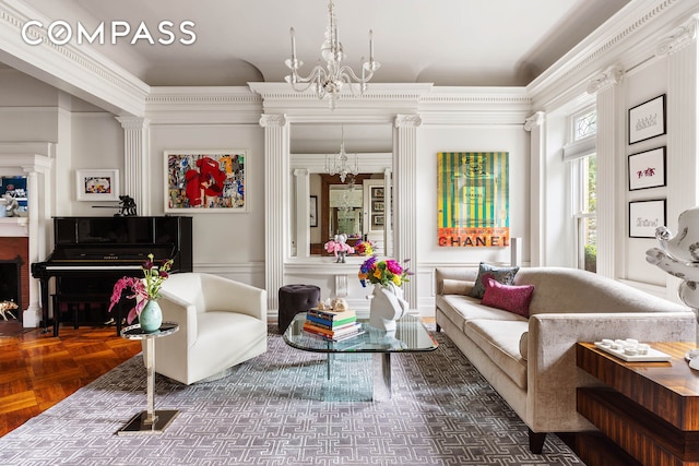 sitting room with a notable chandelier, wainscoting, crown molding, and a decorative wall