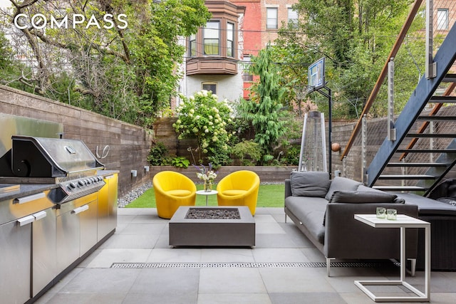 view of patio / terrace featuring stairs, grilling area, an outdoor living space with a fire pit, and fence