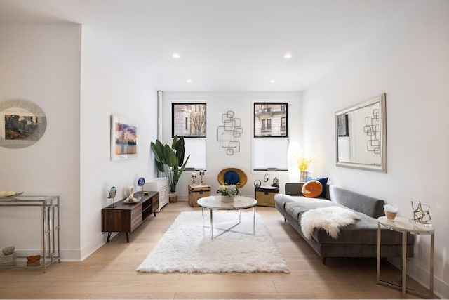 living area with recessed lighting, baseboards, and light wood-style floors