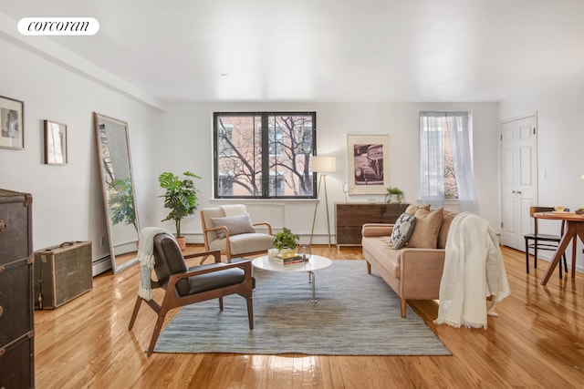 living room featuring light wood finished floors, plenty of natural light, and visible vents