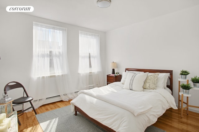 bedroom with visible vents and wood finished floors