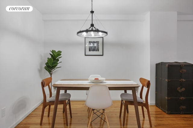 dining room featuring breakfast area, visible vents, baseboards, and wood finished floors