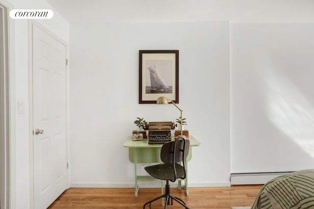 bedroom featuring a baseboard radiator, light wood-type flooring, visible vents, and baseboards