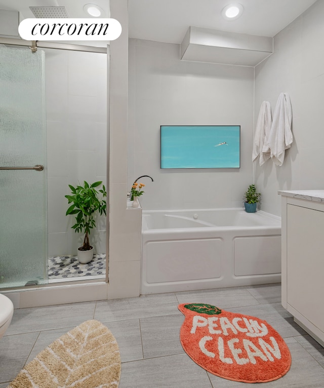 bathroom featuring a stall shower, a garden tub, toilet, and tile patterned floors