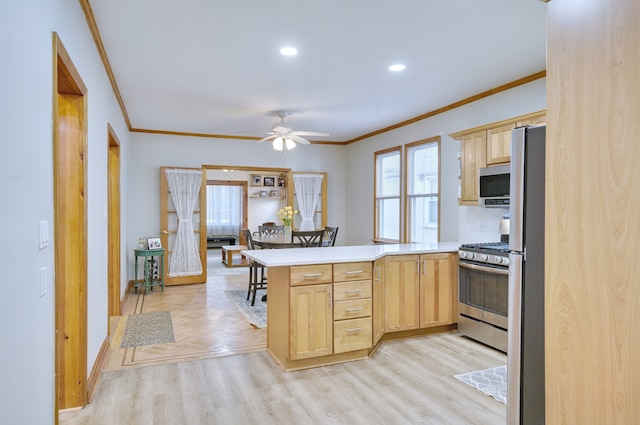 kitchen featuring a peninsula, appliances with stainless steel finishes, light brown cabinets, and crown molding