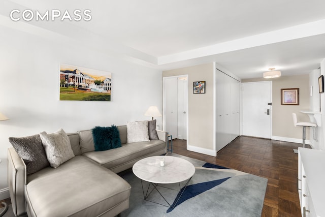 living room featuring baseboards