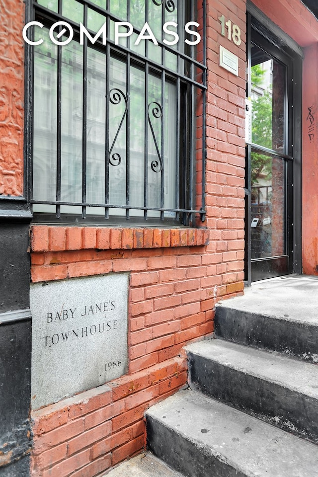 property entrance with brick siding