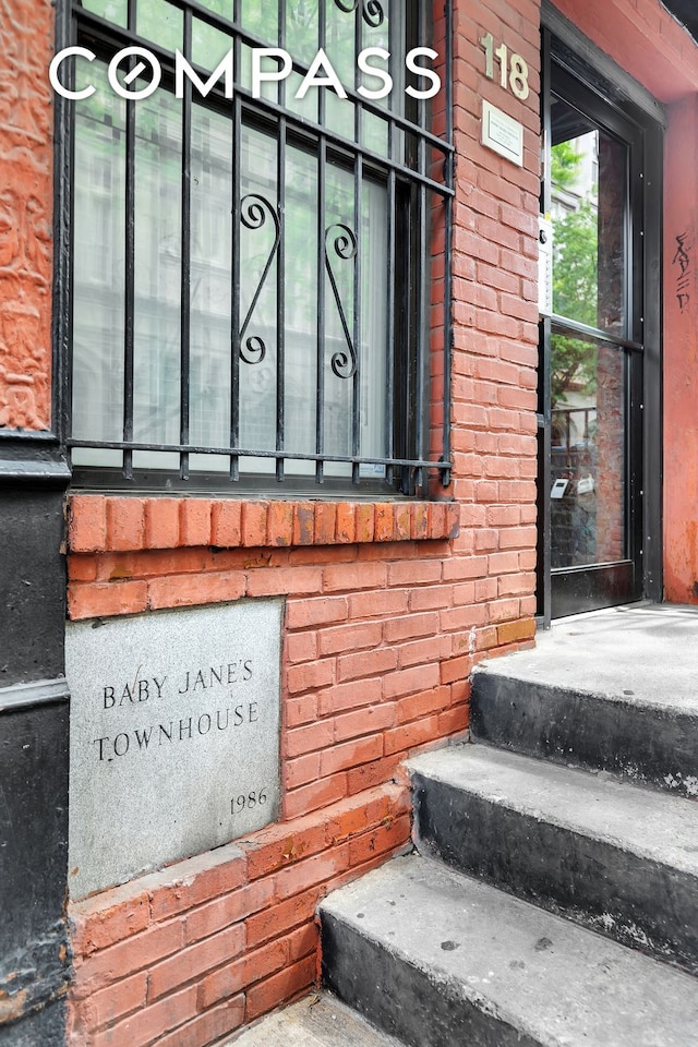 view of exterior entry with brick siding