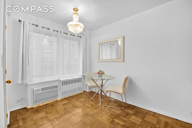 dining area featuring baseboards, a notable chandelier, an AC wall unit, and radiator heating unit