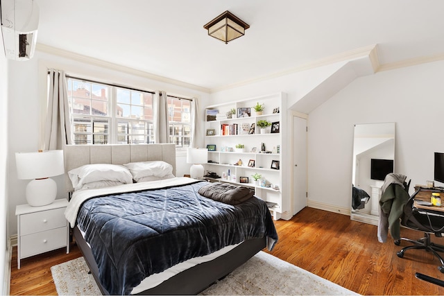 bedroom featuring light wood finished floors, baseboards, and crown molding