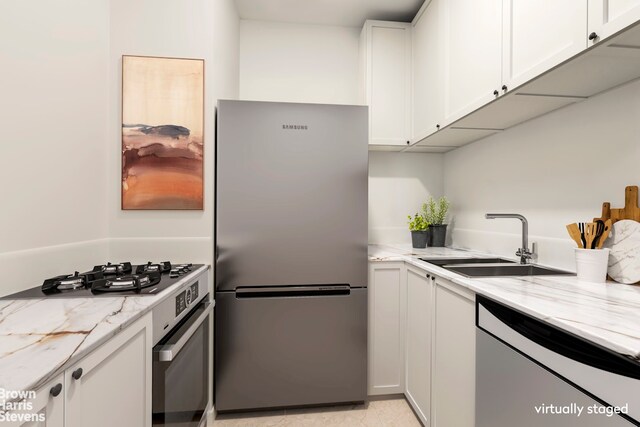 44 W 62nd St Unit 6E, New York City, NY 10023 - kitchen featuring freestanding refrigerator, range, a sink, white dishwasher, and white cabinets