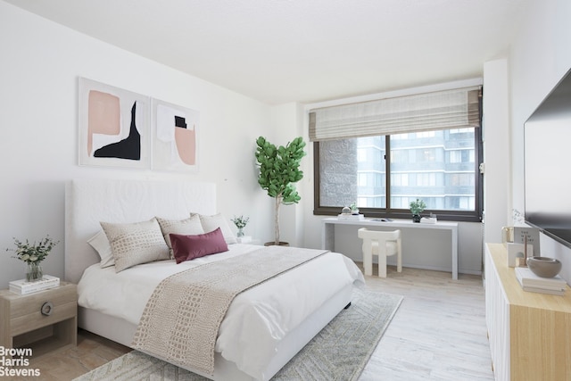 bedroom featuring light wood-style floors